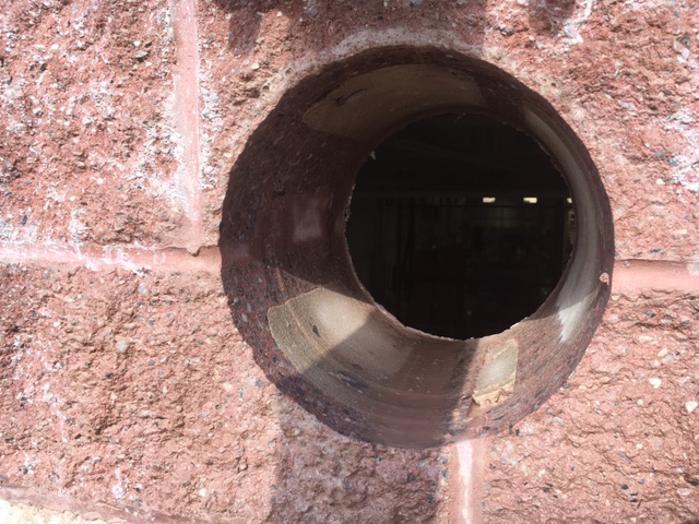 hole cut in brick wall